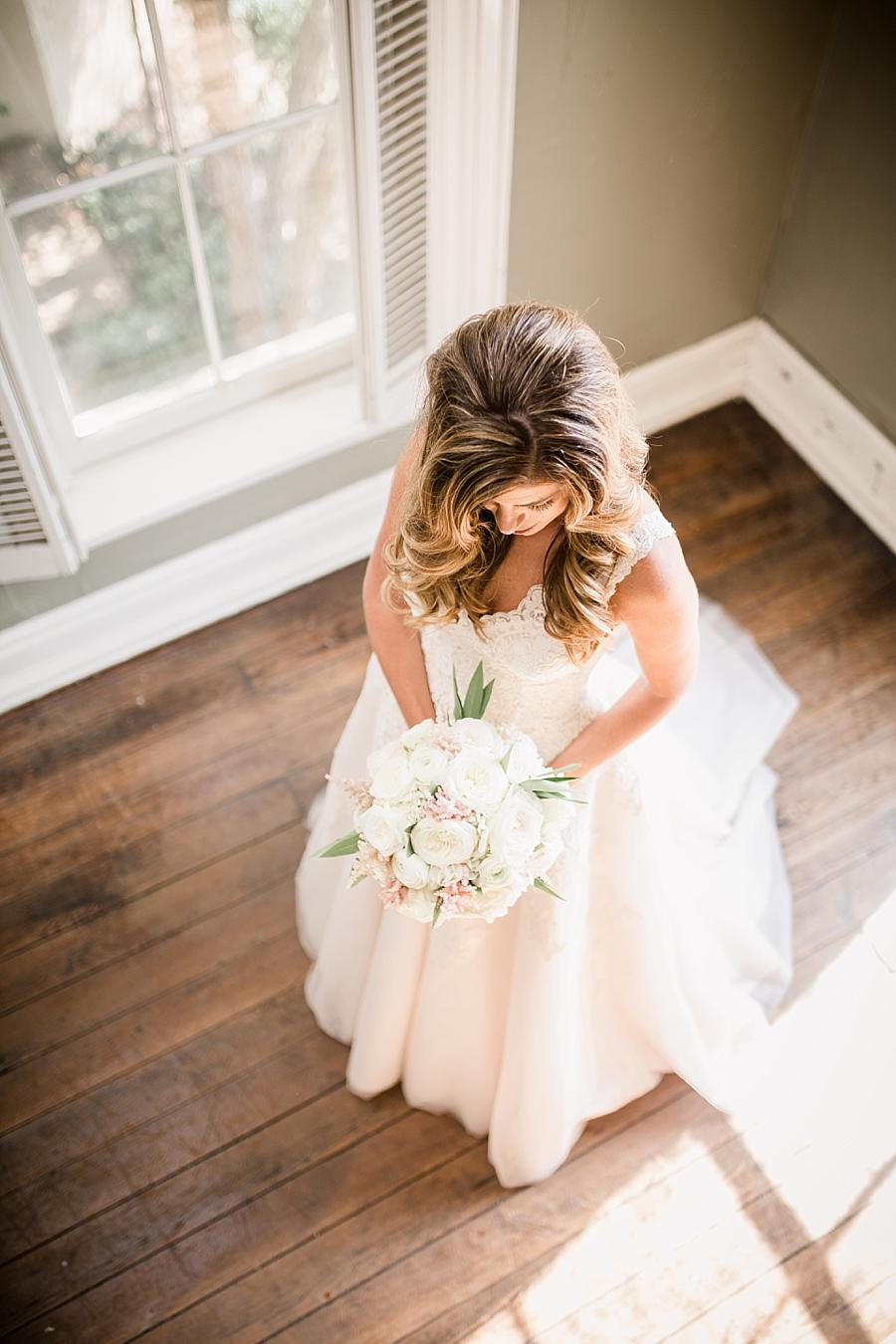 Overview of bride looking at flowers at this East Ivy Mansion Wedding session by Knoxville Wedding Photographer, Amanda May Photos.