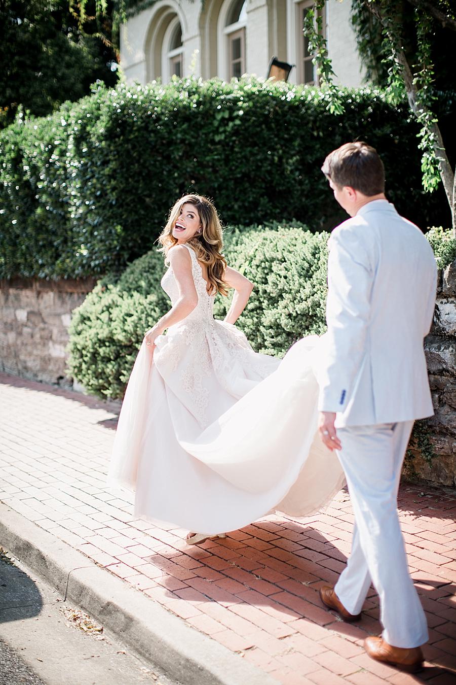 Holding dress up while walking at this East Ivy Mansion Wedding session by Knoxville Wedding Photographer, Amanda May Photos.