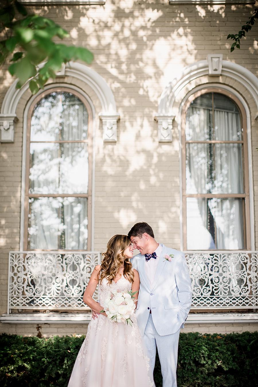 Looking at each other smiling at this East Ivy Mansion Wedding session by Knoxville Wedding Photographer, Amanda May Photos.