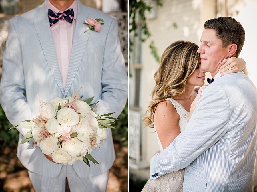 Groom holding flowers and bride holding onto groom by neck at this East Ivy Mansion Wedding session by Knoxville Wedding Photographer, Amanda May Photos.