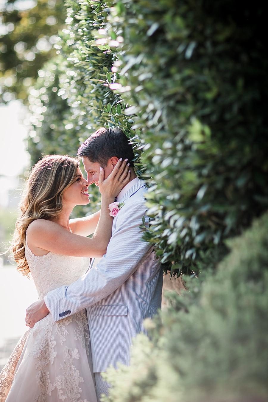 Holding groom by cheek smiling at this East Ivy Mansion Wedding session by Knoxville Wedding Photographer, Amanda May Photos.