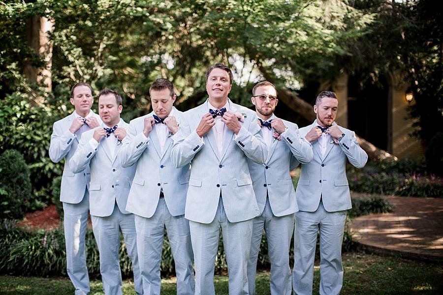 Groomsmen fixing their bow ties at this East Ivy Mansion Wedding session by Knoxville Wedding Photographer, Amanda May Photos.