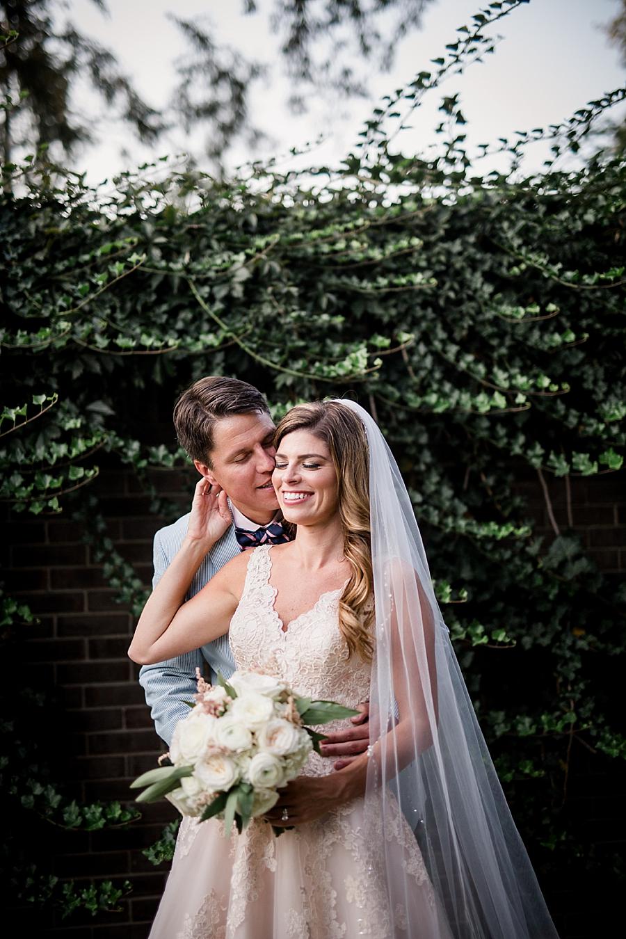 Kissing her cheek at this East Ivy Mansion Wedding session by Knoxville Wedding Photographer, Amanda May Photos.