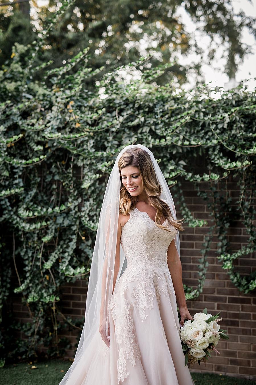 Bride looking down at this East Ivy Mansion Wedding session by Knoxville Wedding Photographer, Amanda May Photos.