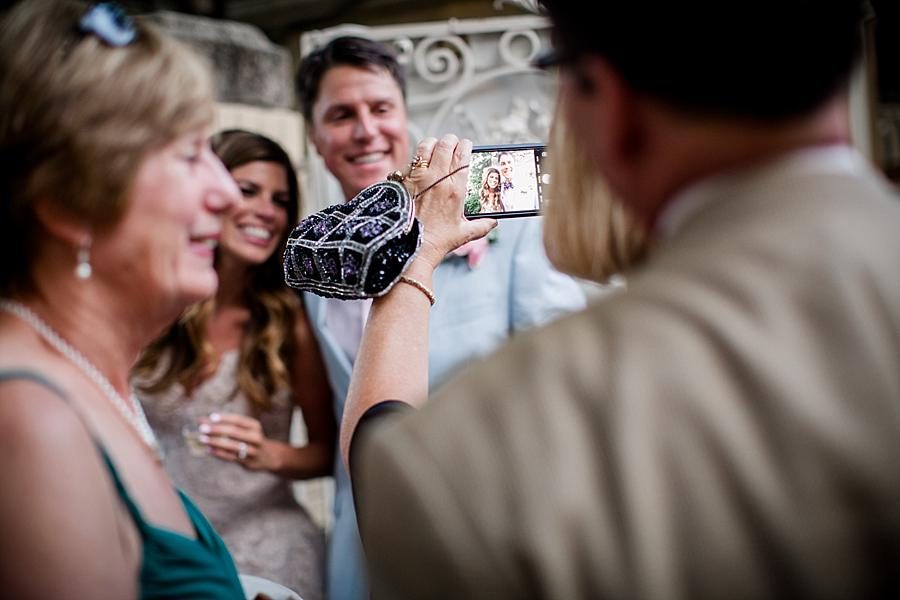 Guest taking picture of bride and groom at this East Ivy Mansion Wedding session by Knoxville Wedding Photographer, Amanda May Photos.