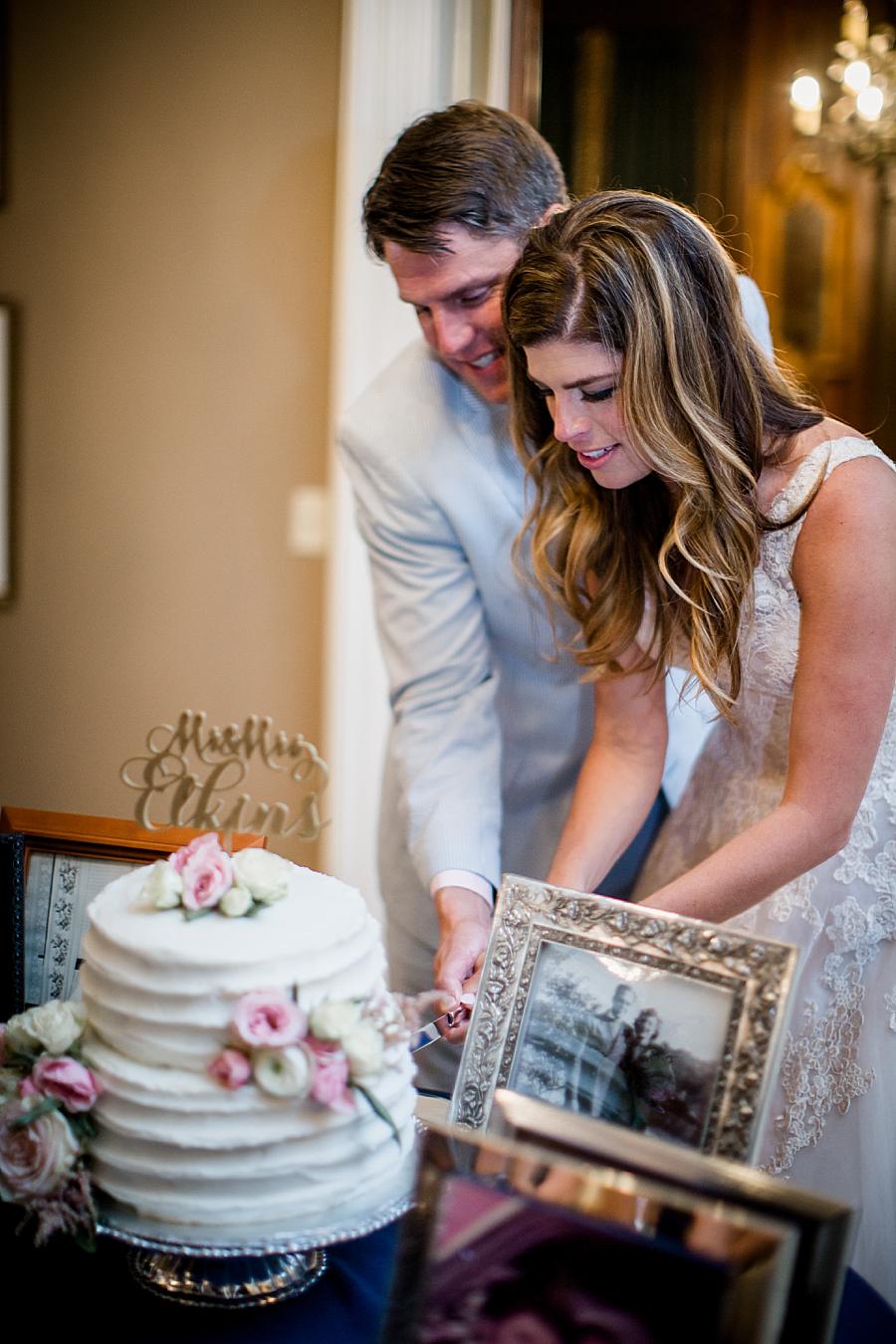 Couple cutting the cake at this East Ivy Mansion Wedding session by Knoxville Wedding Photographer, Amanda May Photos.