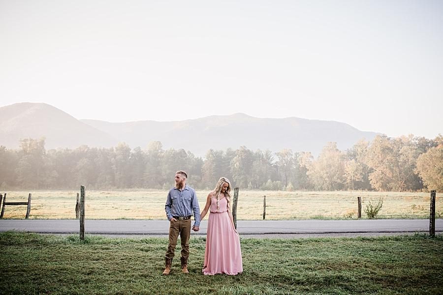 Holding hands in front of fence line at this Townsend Anniversary session by Knoxville Wedding Photographer, Amanda May Photos.