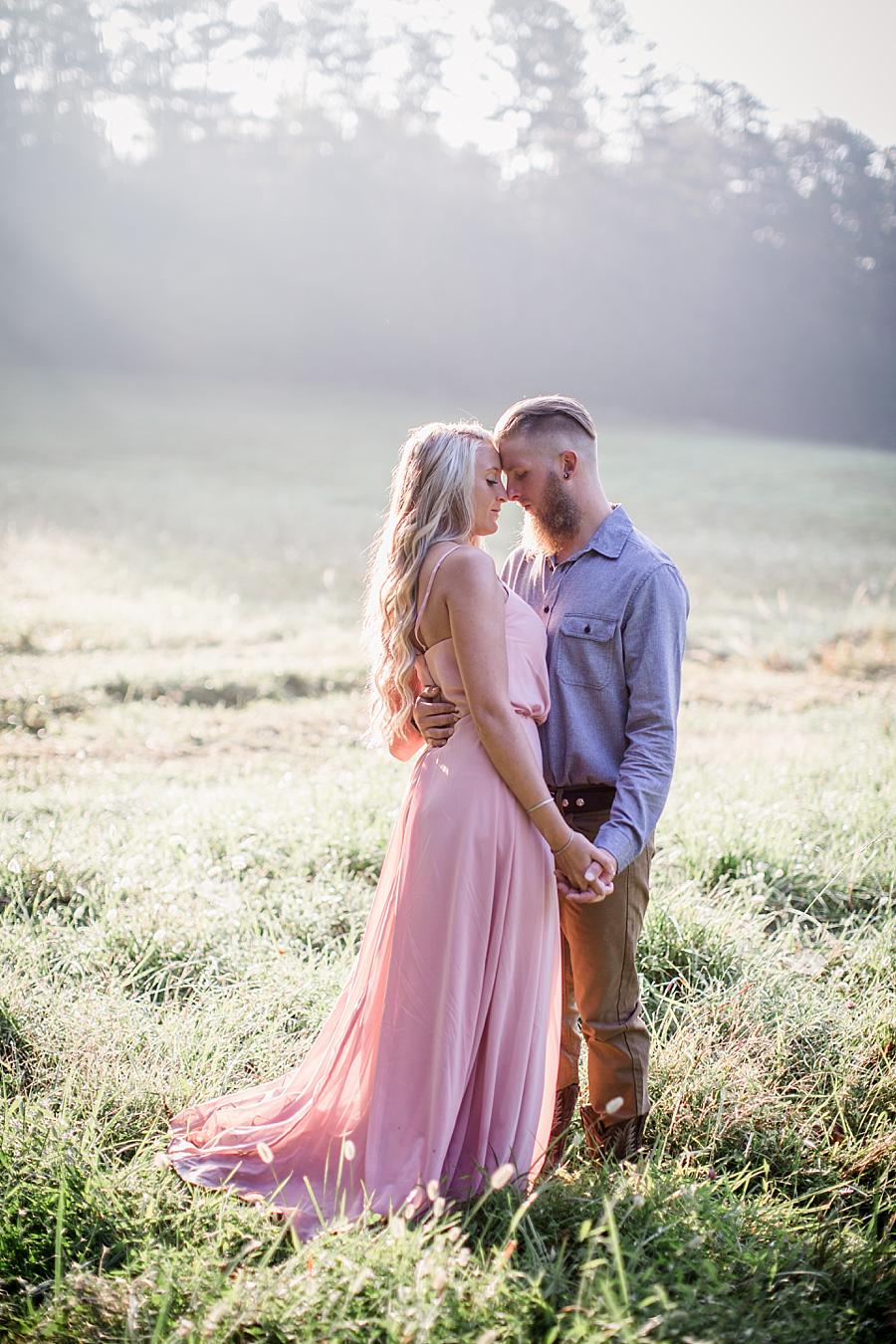 Hugging close in grass at this Townsend Anniversary session by Knoxville Wedding Photographer, Amanda May Photos.