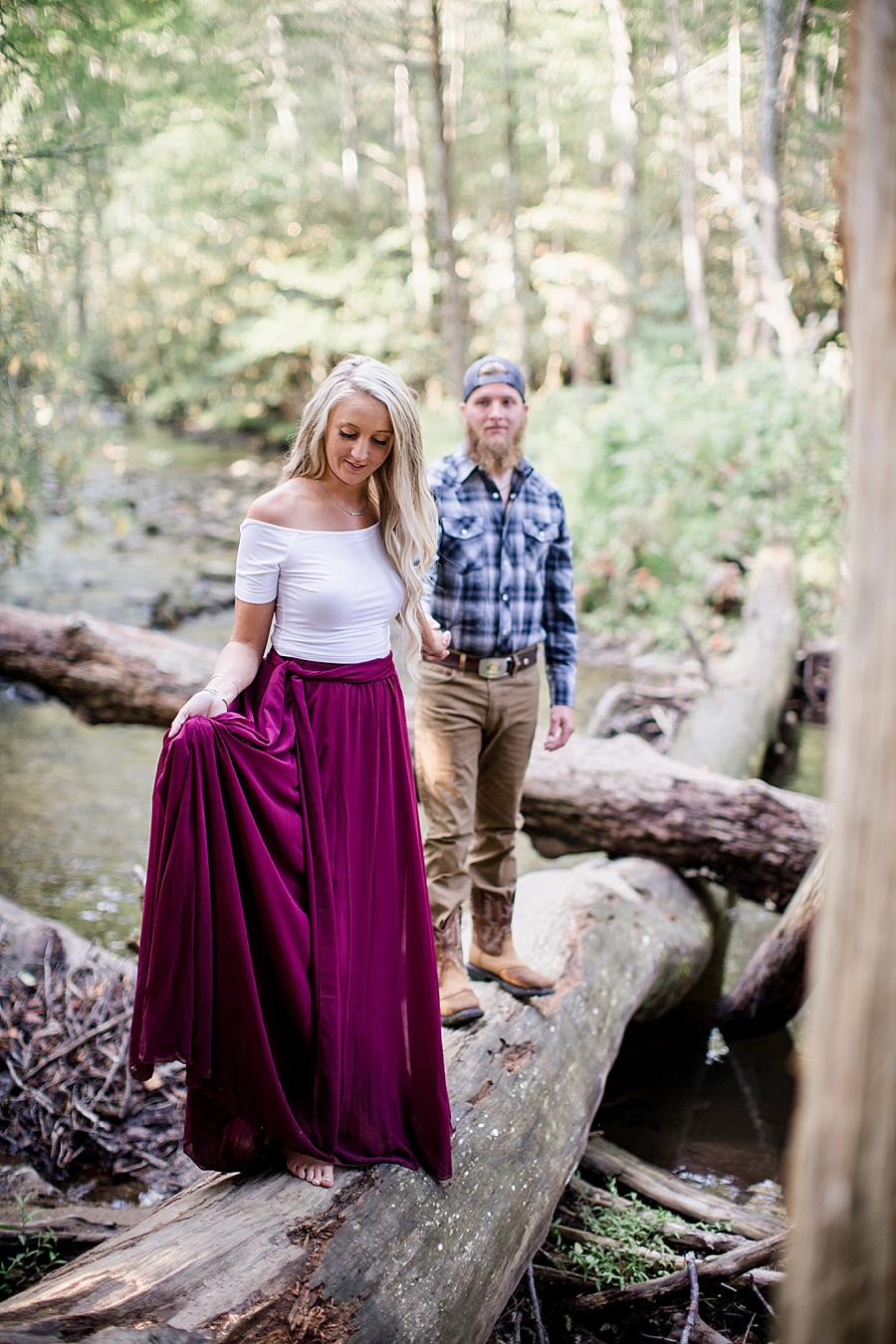 Walking across log on river at this Townsend Anniversary session by Knoxville Wedding Photographer, Amanda May Photos.