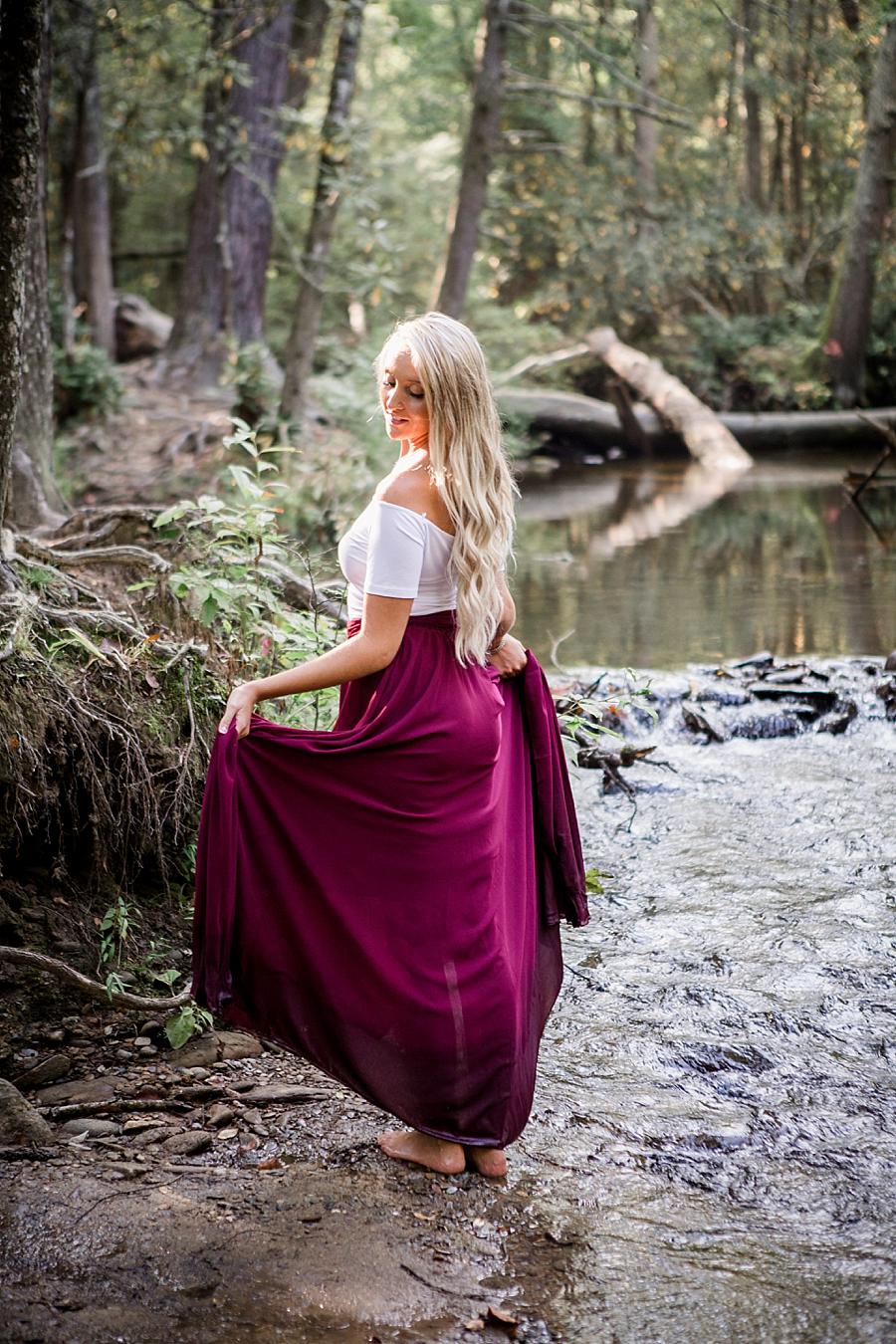 Standing in creek by herself at this Townsend Anniversary session by Knoxville Wedding Photographer, Amanda May Photos.