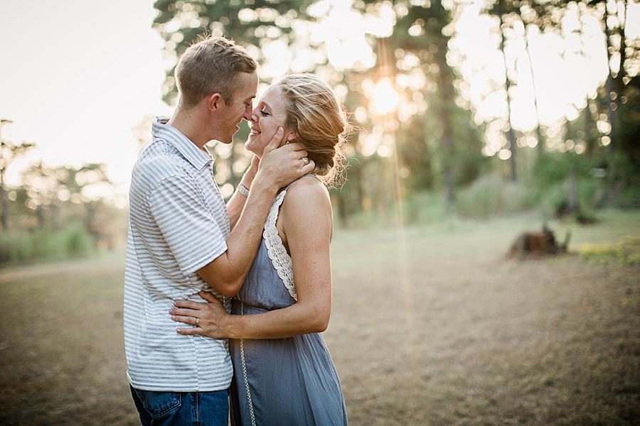 Cupping her face at this Air Force Engagement Session by Knoxville Wedding Photographer, Amanda May Photos.