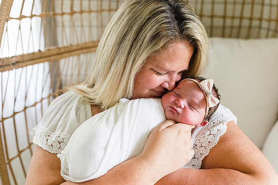 mom holding daughter at this newborn session