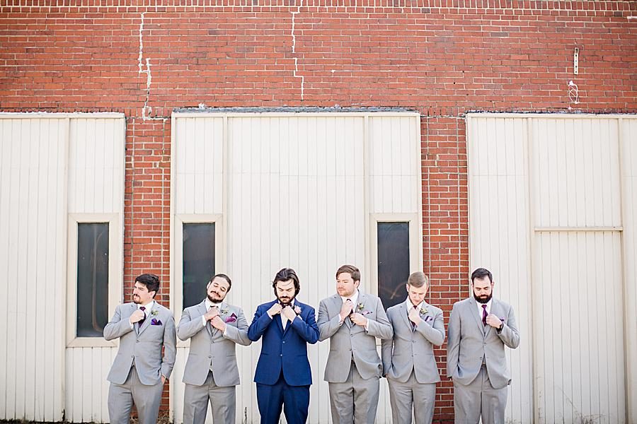 Straightening ties at this Relix Theater Wedding by Knoxville Wedding Photographer, Amanda May Photos.