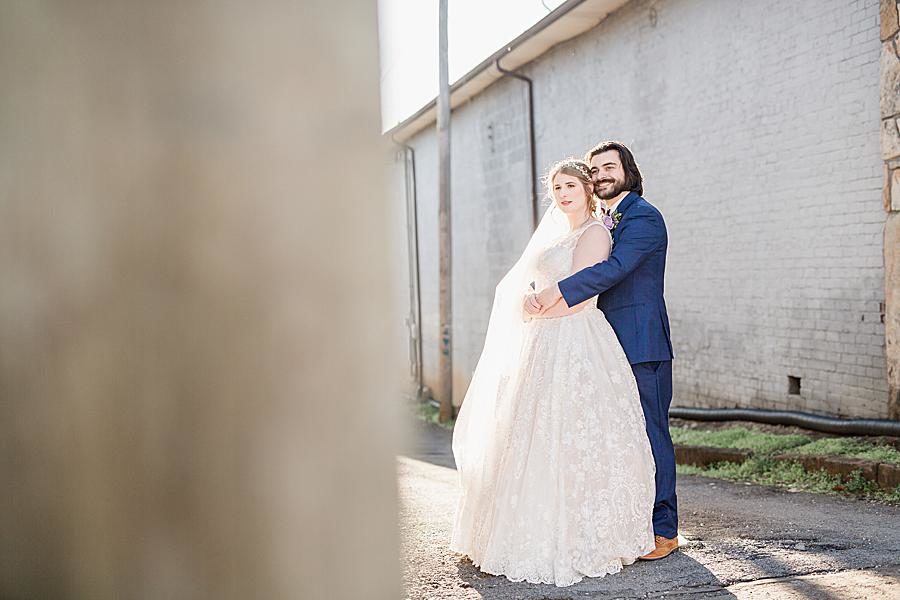 Arms around waist at this Relix Theater Wedding by Knoxville Wedding Photographer, Amanda May Photos.