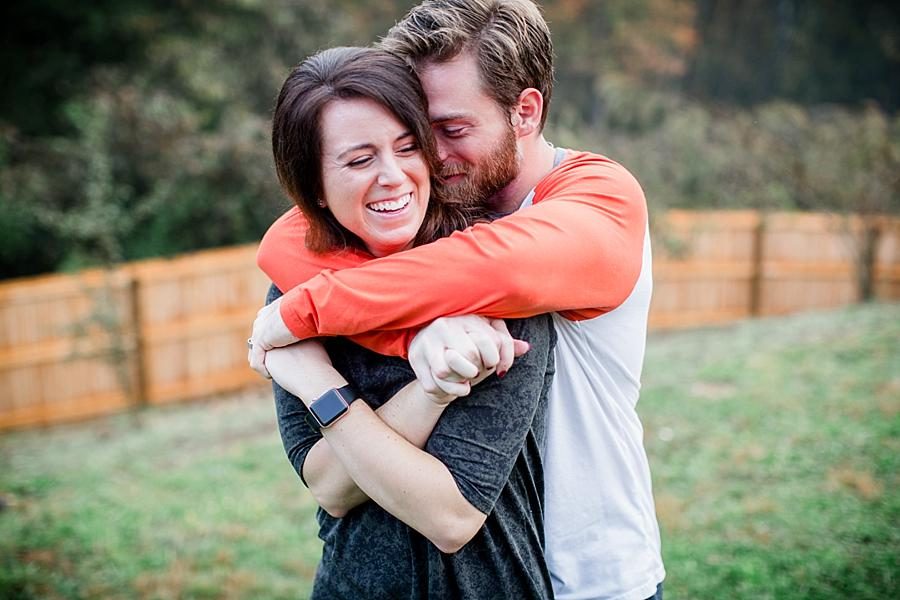 Hugging her from behind for these lifestyle photos by Knoxville Wedding Photographer, Amanda May Photos.