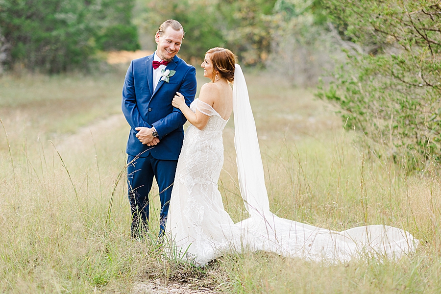 standing in tall grass at this stone gate farm wedding