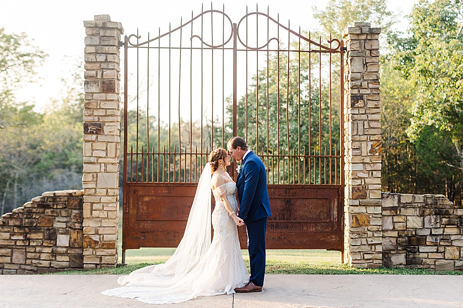 kissing at this stone gate farm wedding