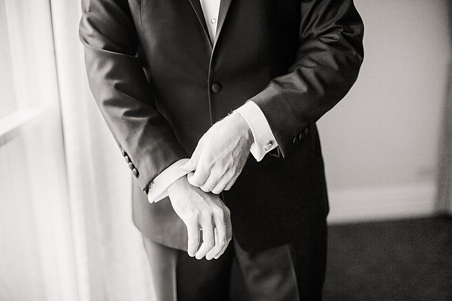 Groom fixing sleeves by Knoxville Wedding Photographer, Amanda May Photos.
