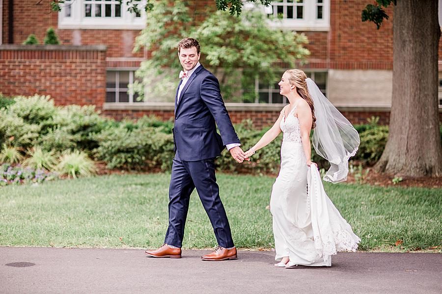 Holding hands and walking at this The Olmsted Wedding by Knoxville Wedding Photographer, Amanda May Photos.