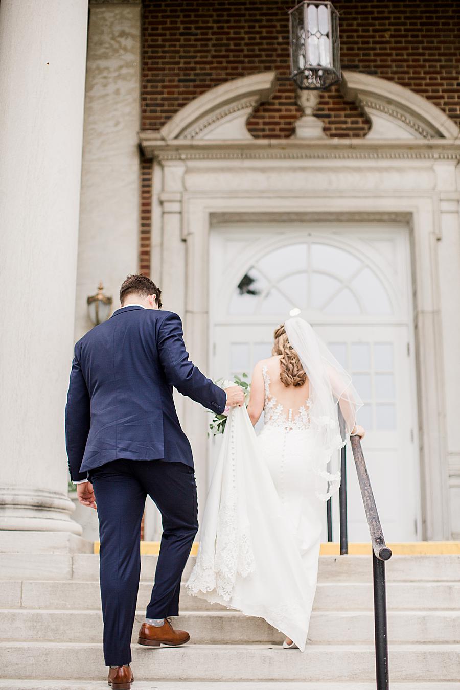 Bride and groom walking up the stairs by Knoxville Wedding Photographer, Amanda May Photos.