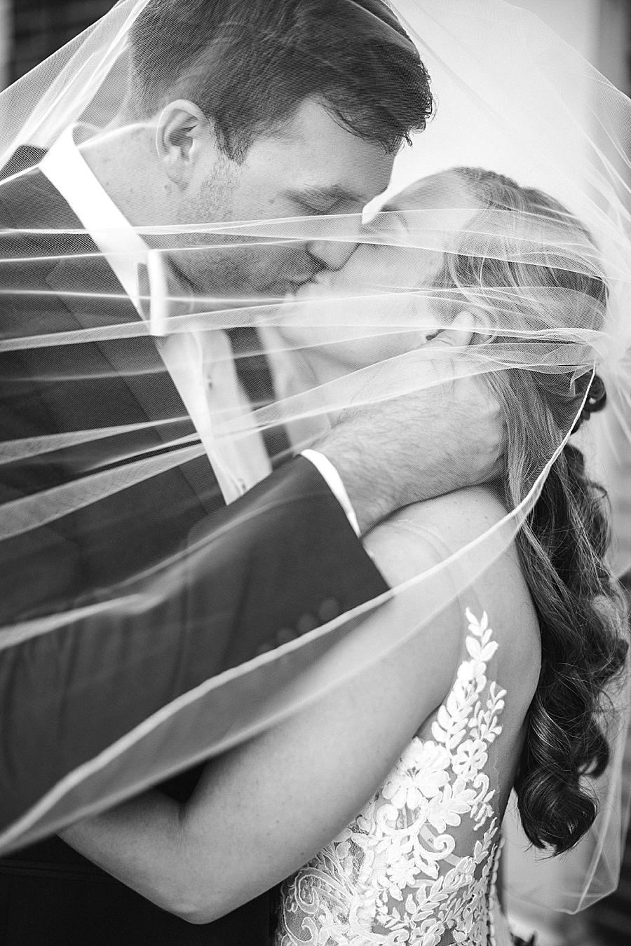 Kissing under the veil at this The Olmsted Wedding by Knoxville Wedding Photographer, Amanda May Photos.