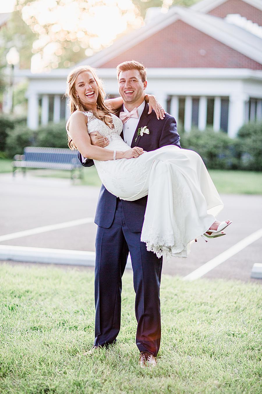 Princess carry at this The Olmsted Wedding by Knoxville Wedding Photographer, Amanda May Photos.