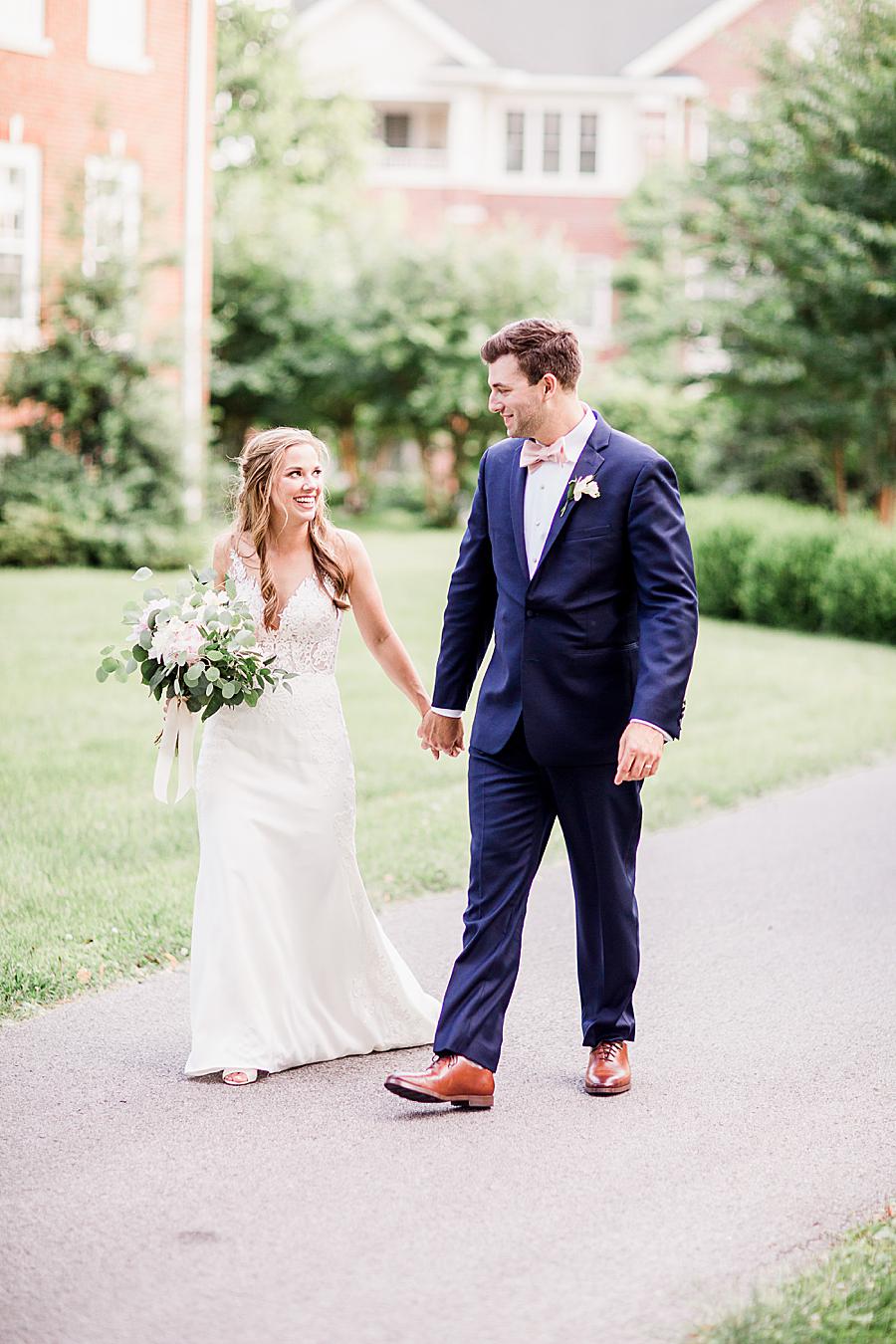 Walking and holding hands at this The Olmsted Wedding by Knoxville Wedding Photographer, Amanda May Photos.