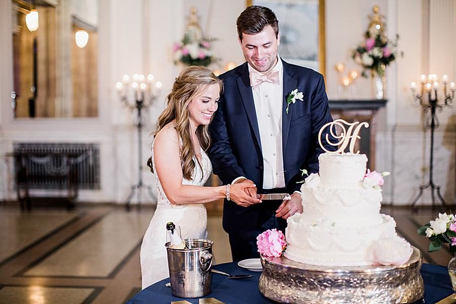 Cutting the cake at this The Olmsted Wedding by Knoxville Wedding Photographer, Amanda May Photos.