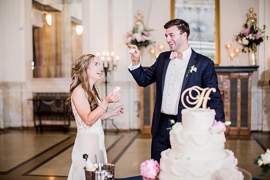 Feeding each other cake at this The Olmsted Wedding by Knoxville Wedding Photographer, Amanda May Photos.