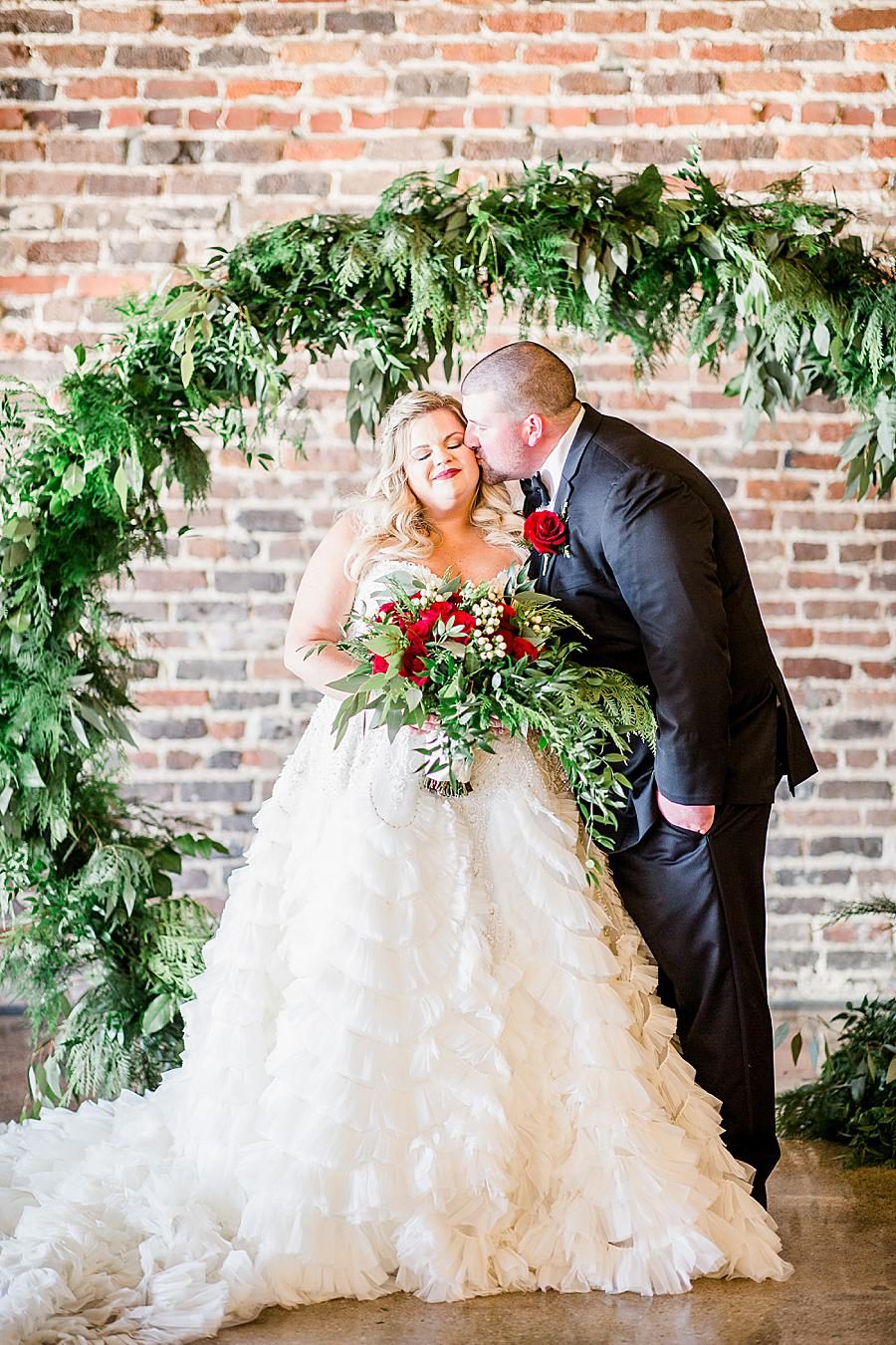 Kiss on the cheek at this The Press Room Wedding by Knoxville Wedding Photographer, Amanda May Photos.