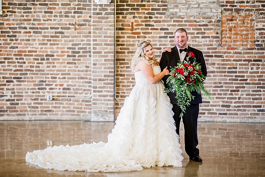 Groom holding bouquet at this The Press Room Wedding by Knoxville Wedding Photographer, Amanda May Photos.