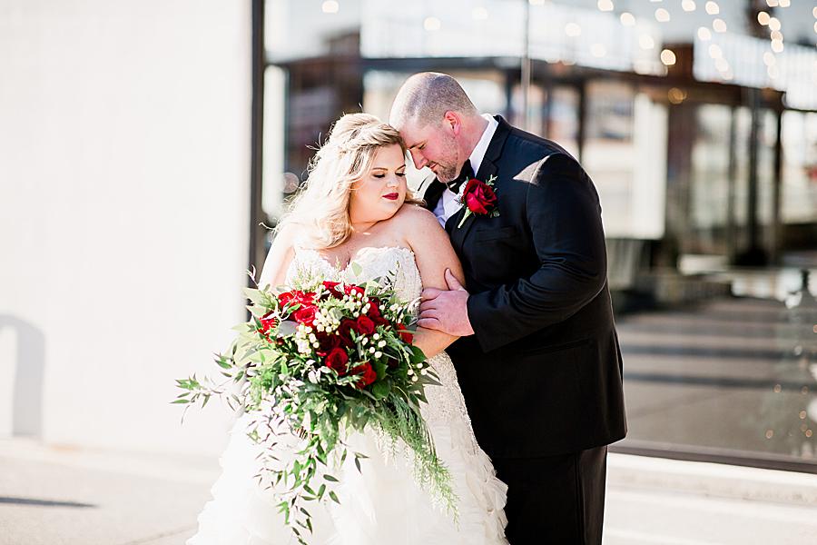 Red rose bridal bouquet at this The Press Room Wedding by Knoxville Wedding Photographer, Amanda May Photos.