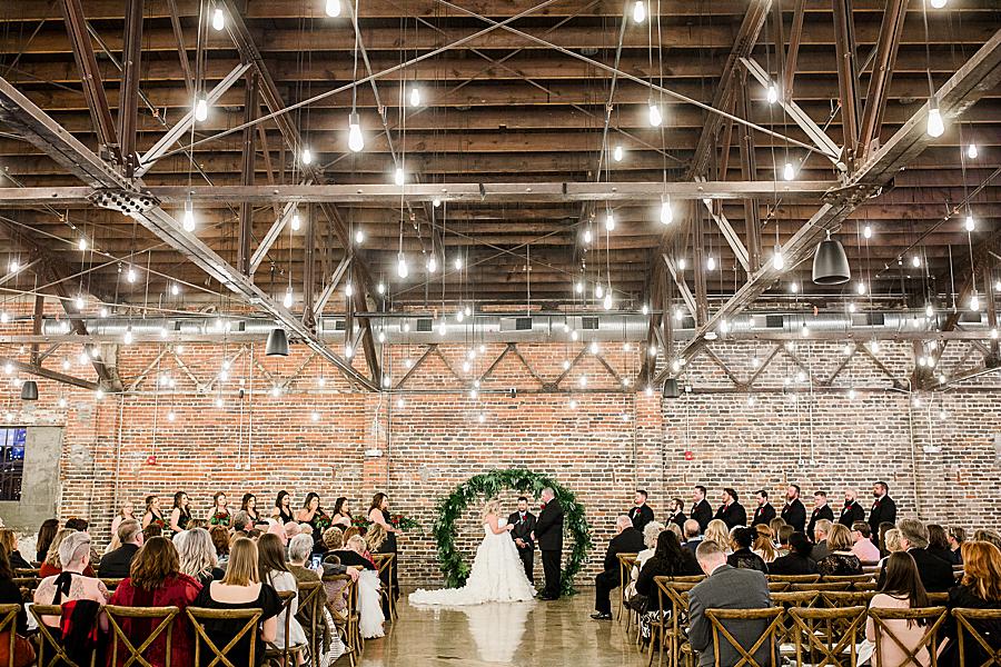 Exchanging rings at this The Press Room Wedding by Knoxville Wedding Photographer, Amanda May Photos.