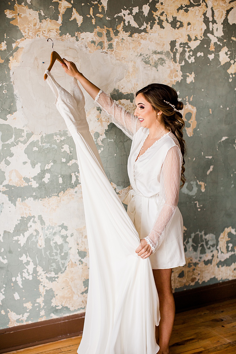Bride holding gown at this Wedding at The Standard by Knoxville Wedding Photographer, Amanda May Photos.