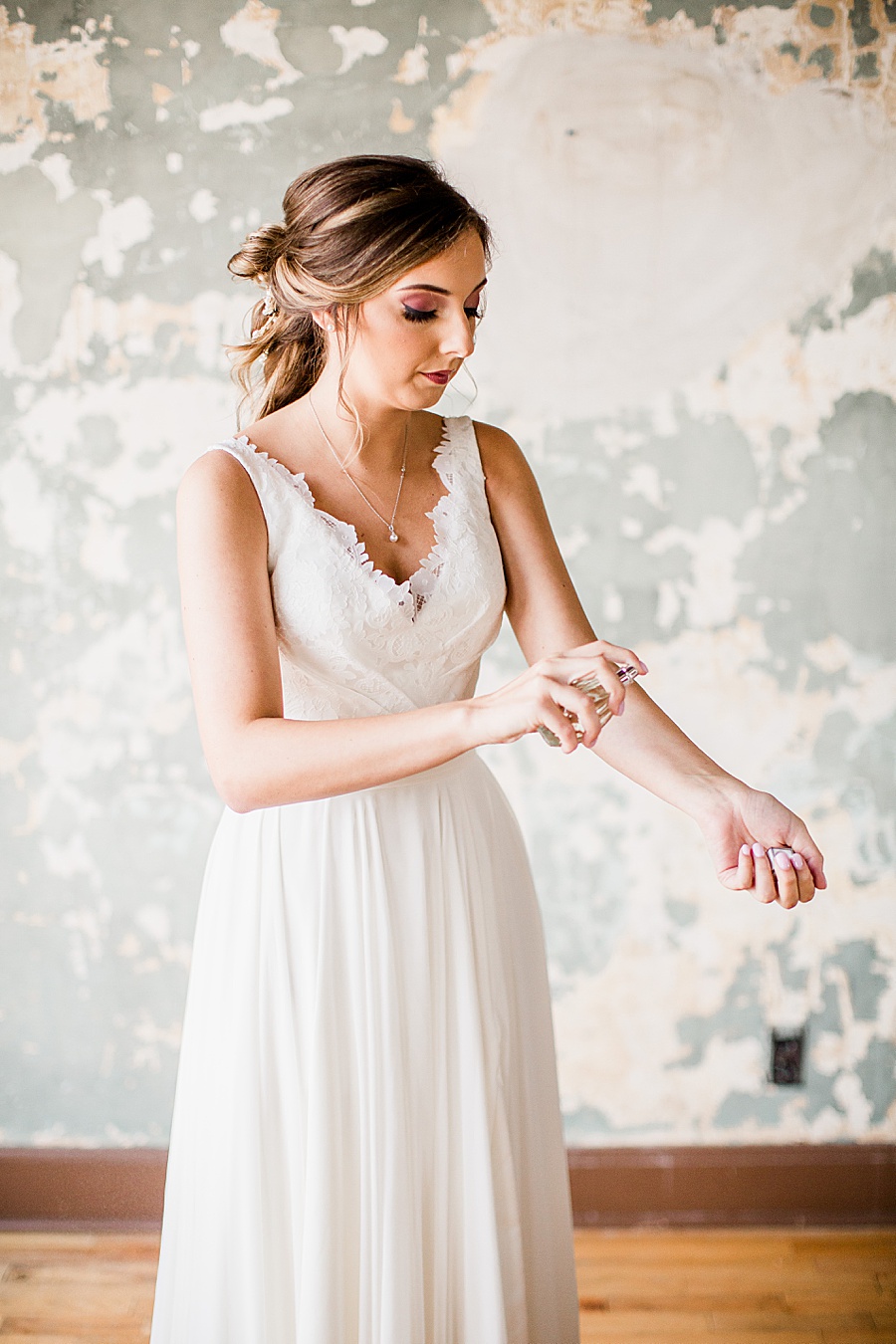 Spritzing perfume at this Wedding at The Standard by Knoxville Wedding Photographer, Amanda May Photos.