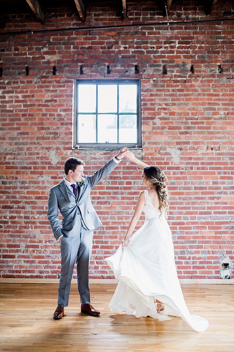 Groom twirling bride by Knoxville Photographer, Amanda May Photos.