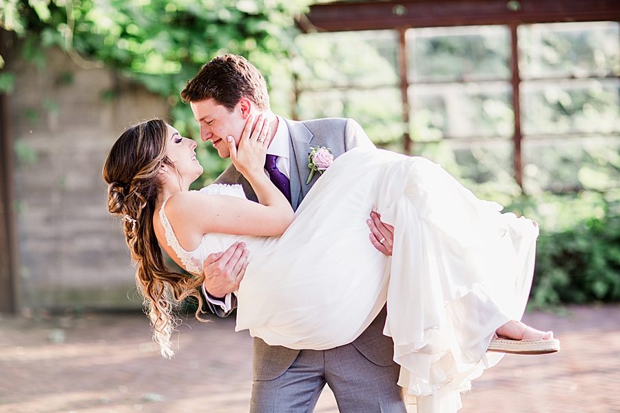 Groom holding bride by Knoxville Photographer, Amanda May Photos.