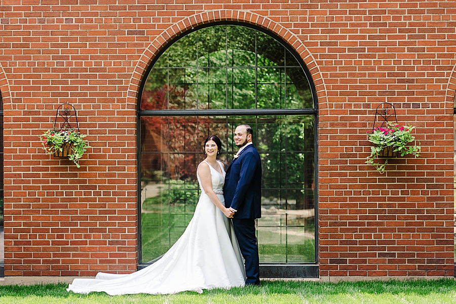 couple in front of arched window at the inn at st. john's