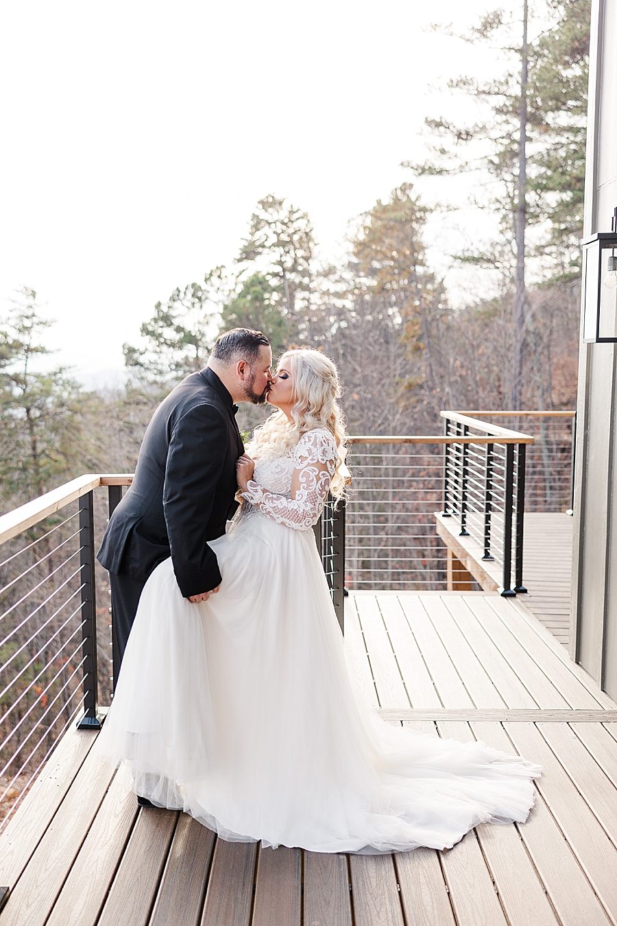 bride and groom standing on balcony