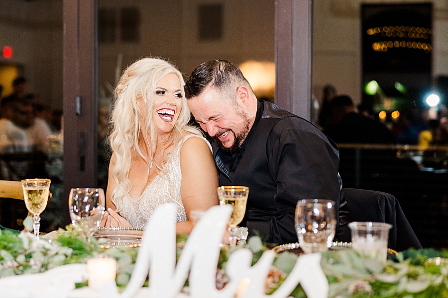 couple laughing during toasts