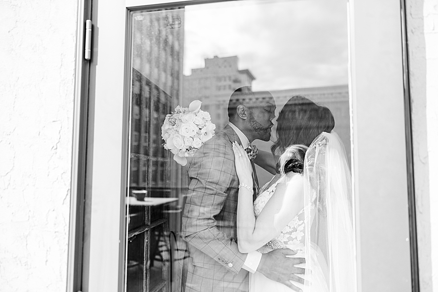 couple behind a window at this urban elopement