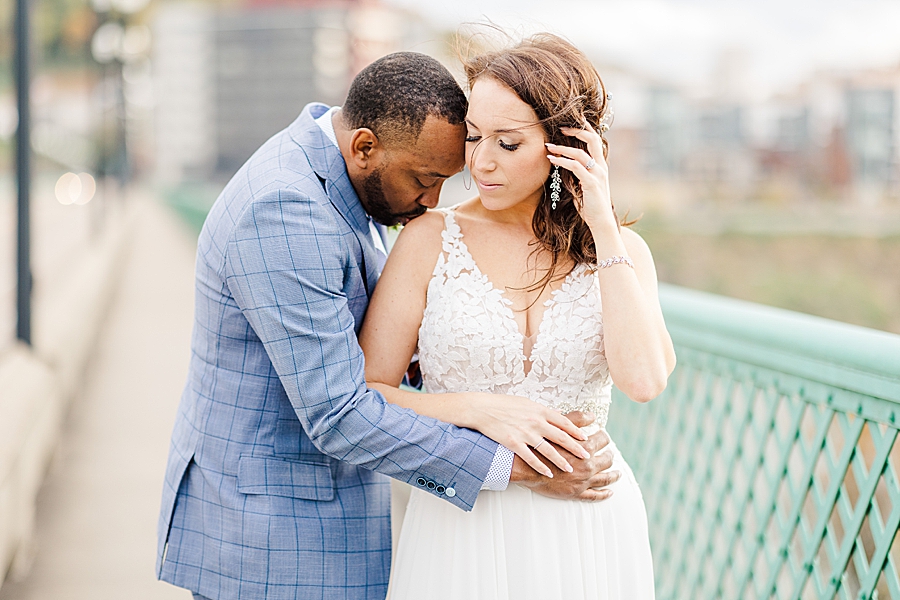 kiss on the shoulder at this urban elopement