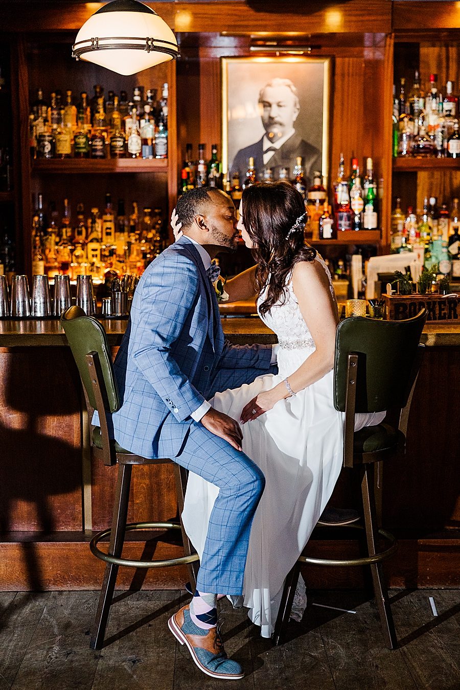 couple kissing on stools at this urban elopement
