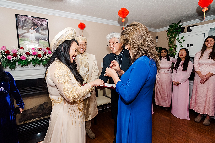 bride receiving jewelry from family