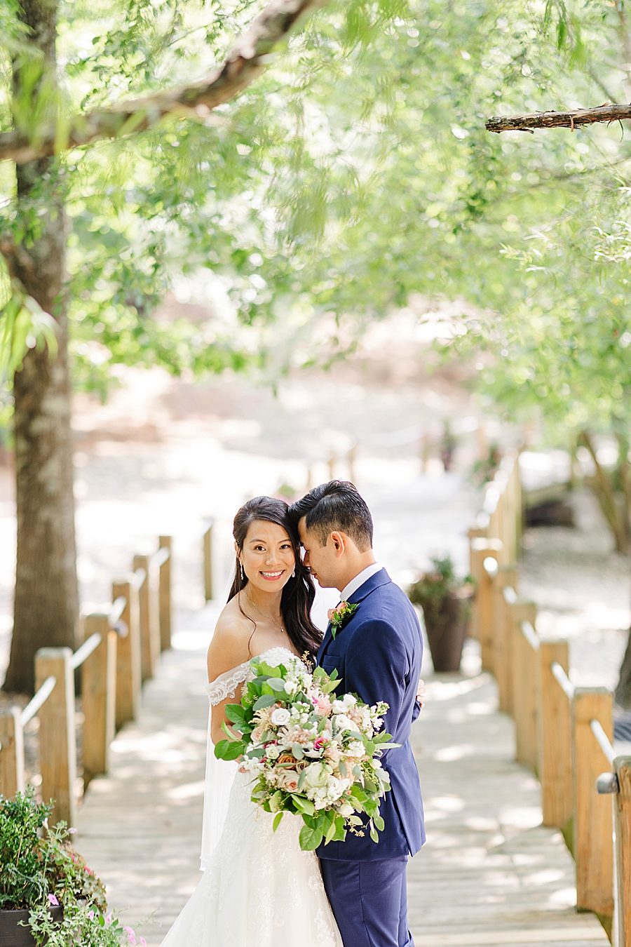 couple on a boardwalk at this vietnamese wedding