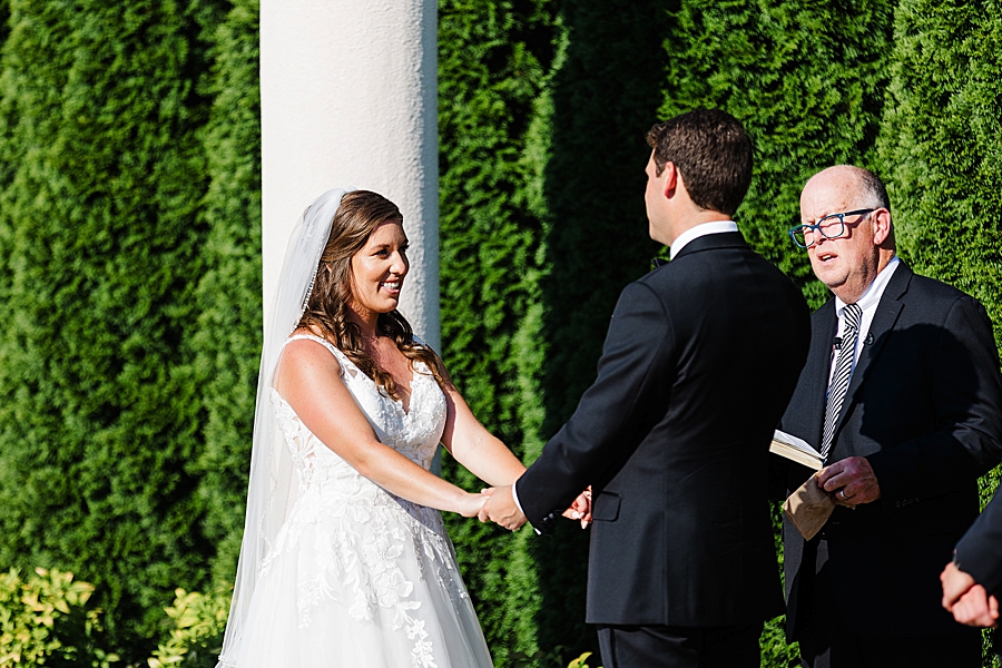 exchanging vows at vineyard wedding at castleton