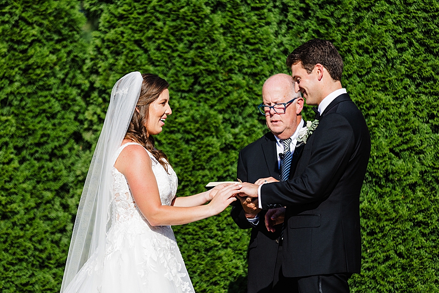 exchanging rings at vineyard wedding at castleton