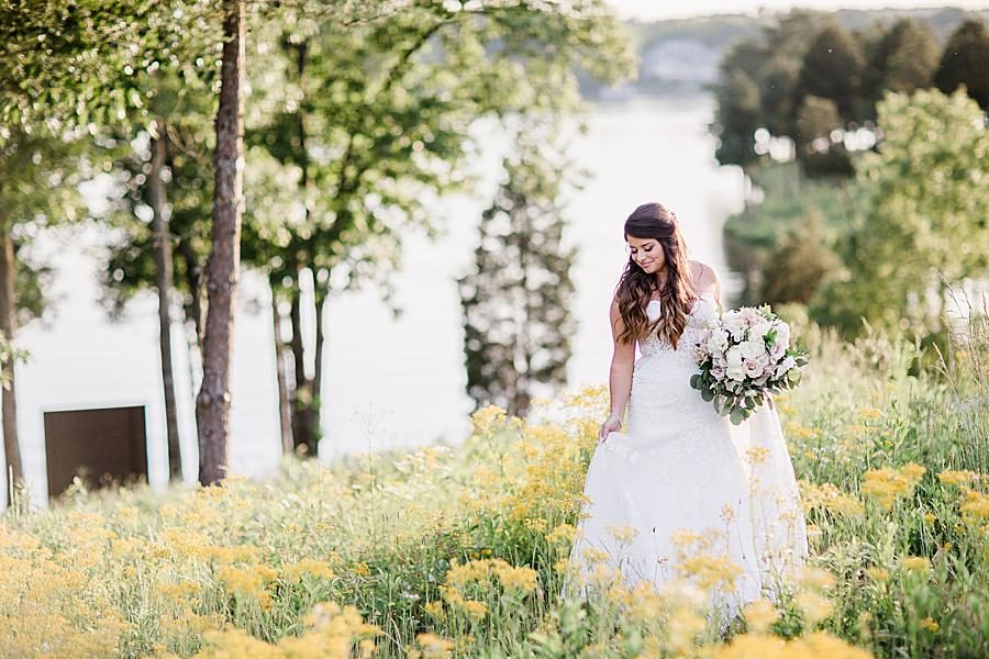 Bride in field of yellow wildflowers at this WindRiver Bridal Portraits by Knoxville Wedding Photographer, Amanda May Photos.