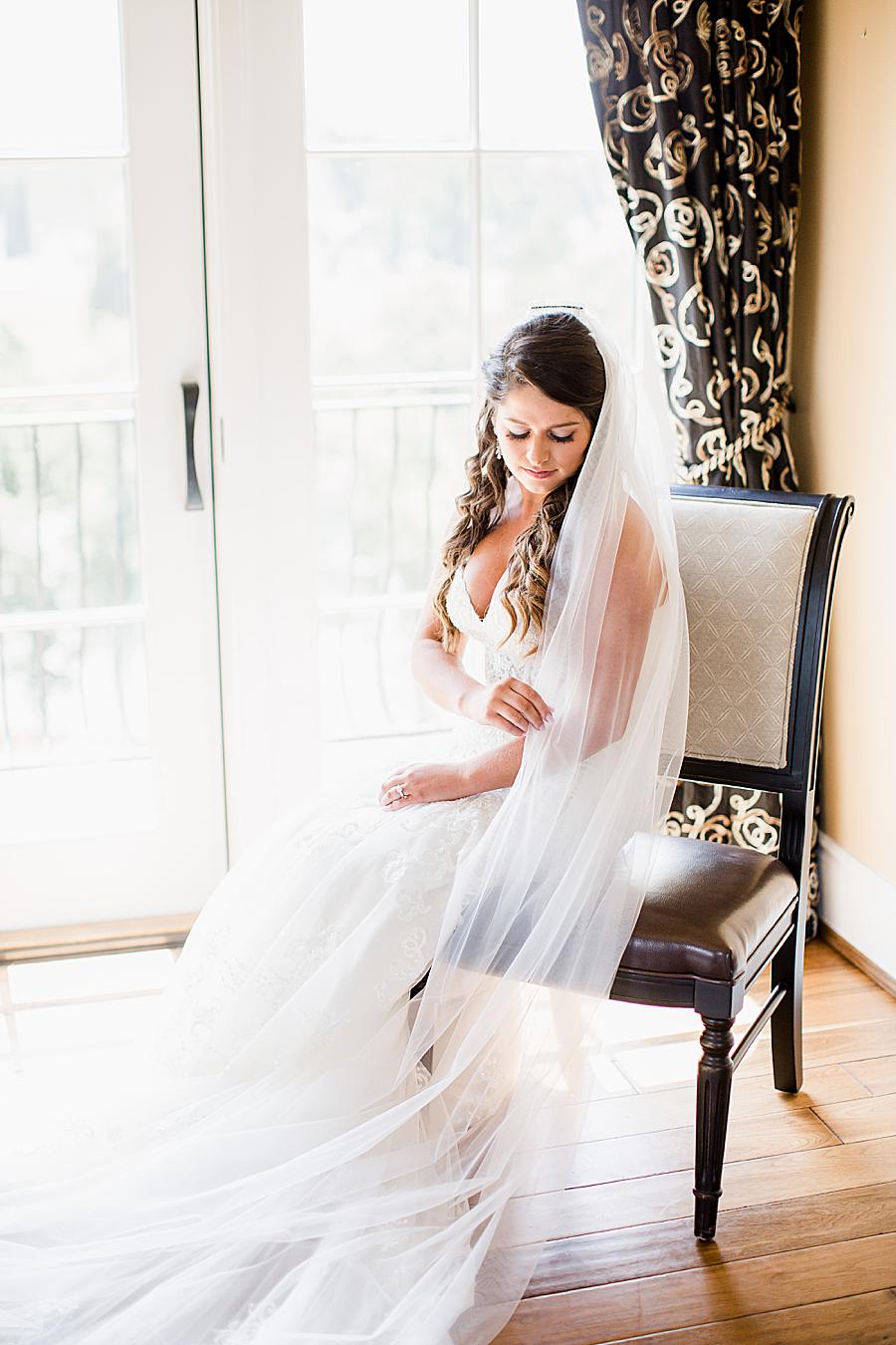 Bride sitting in a chair at this WindRiver Wedding Day by Knoxville Wedding Photographer, Amanda May Photos.