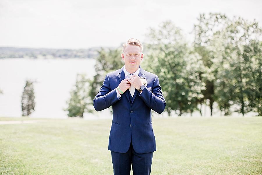 Groom straightening his tie at this WindRiver Wedding Day by Knoxville Wedding Photographer, Amanda May Photos.